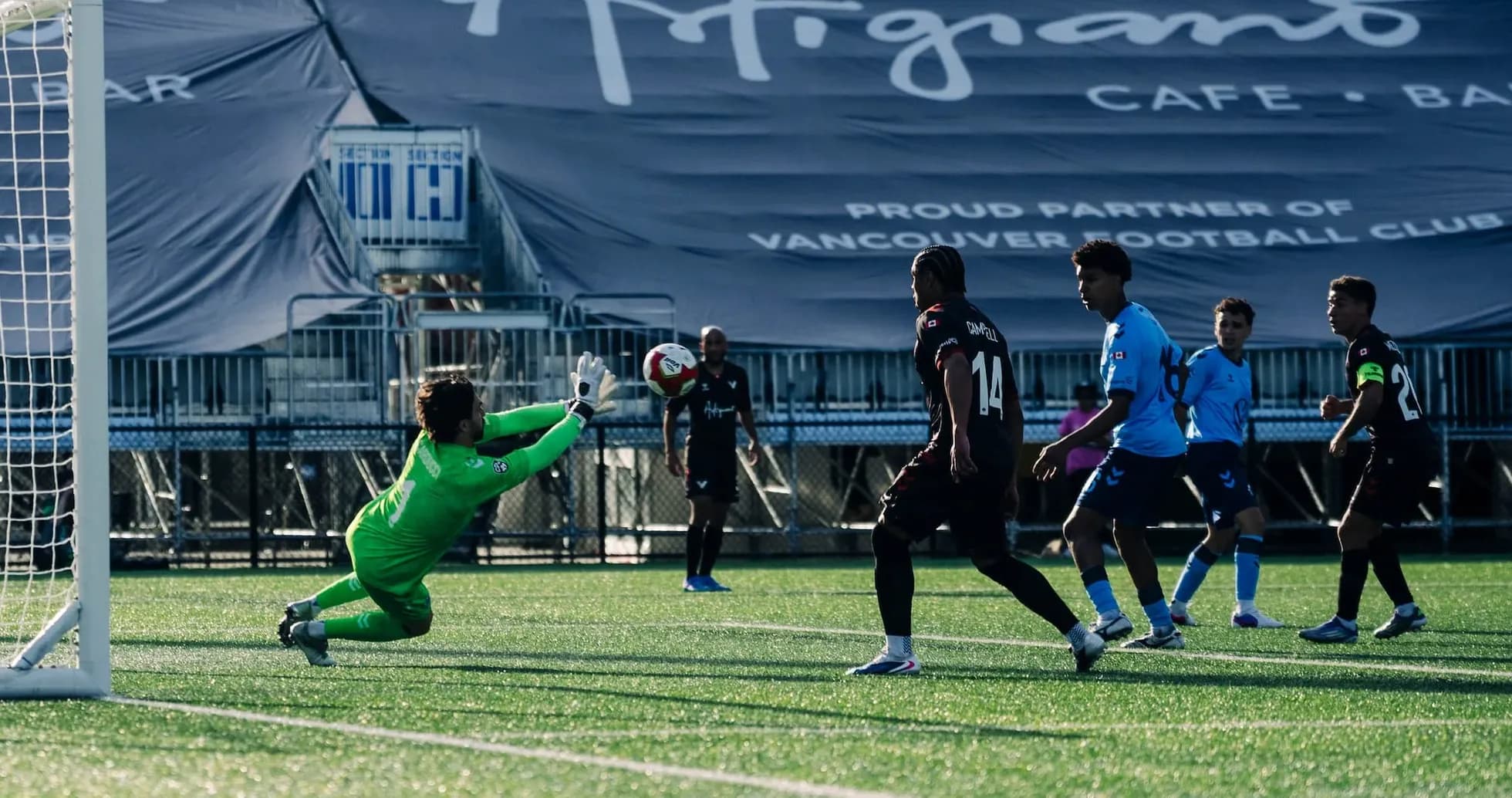 Goalkeeper diving to save a shot on goal Goalkeeper diving to save a shot on goal