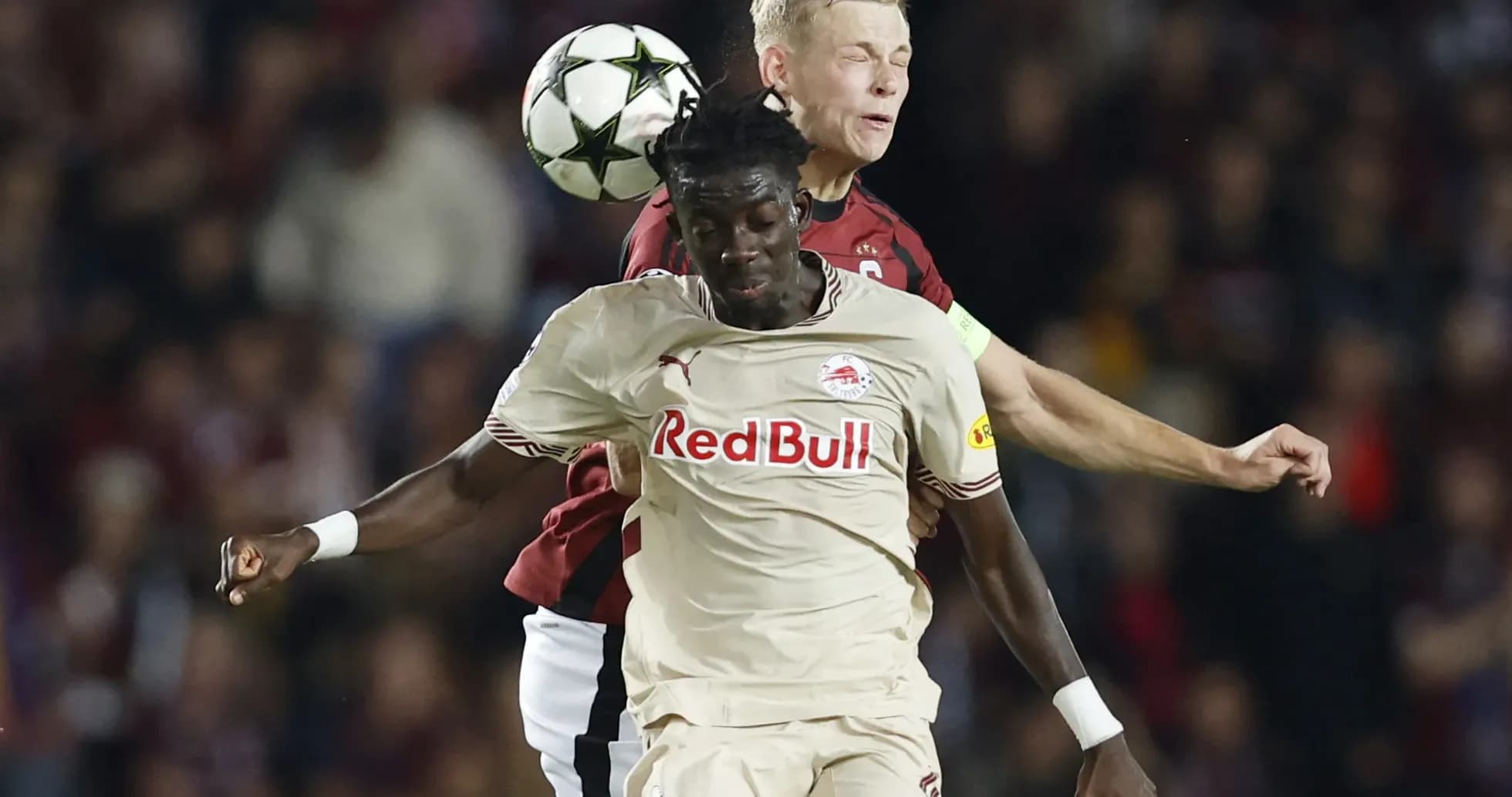Players competing for the ball in Europa League match Players competing for the ball in Europa League match
