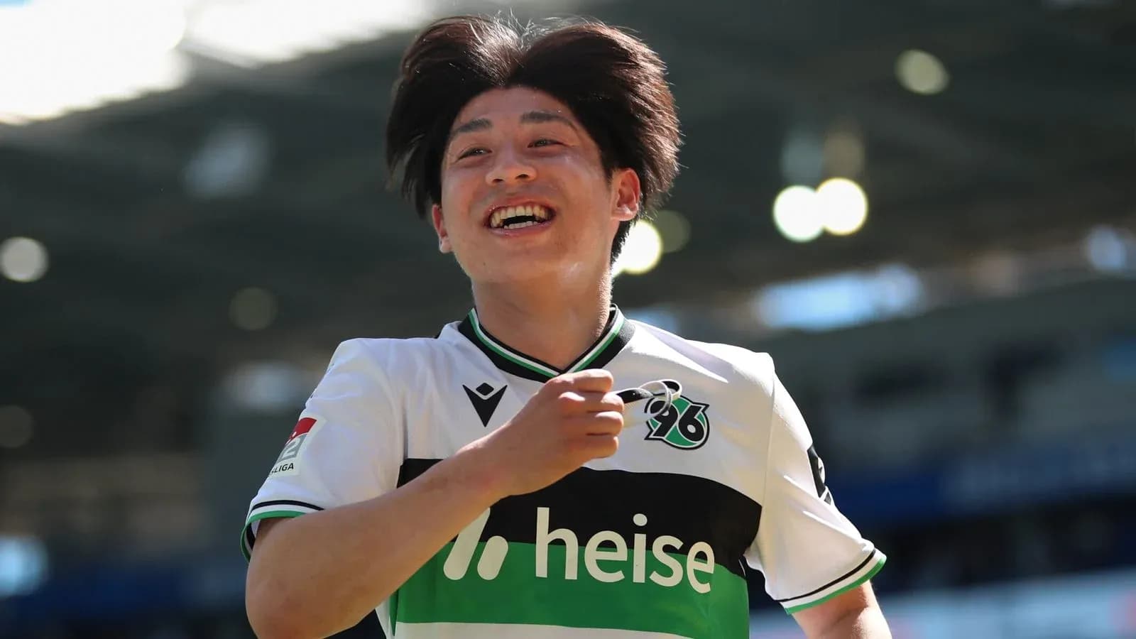 Player celebrating a goal with a joyful expression Player celebrating a goal with a joyful expression