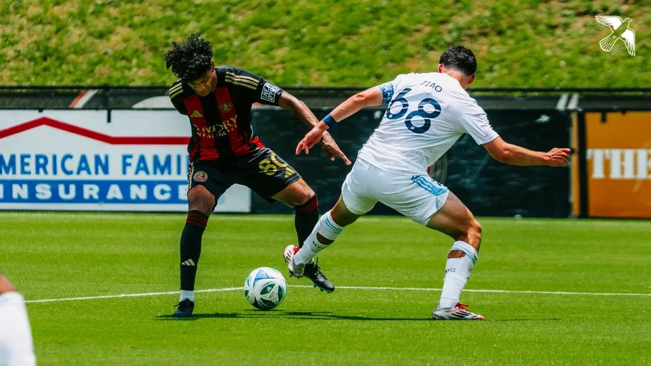 Atlanta United II player tackling New York City II opponent Atlanta United II player tackling New York City II opponent