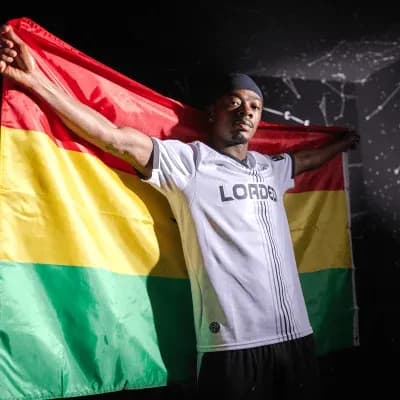 Player holding a flag with red, yellow, and green stripes Player holding a flag with red, yellow, and green stripes