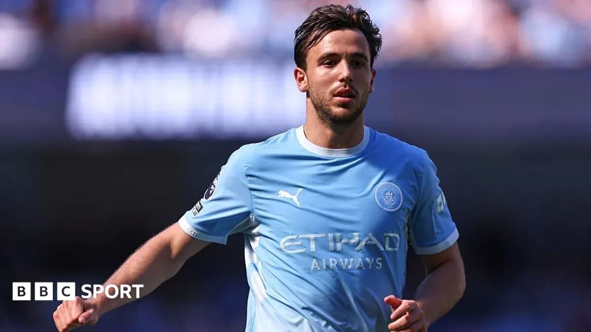 Player in light blue kit running on the field Player in light blue kit running on the field