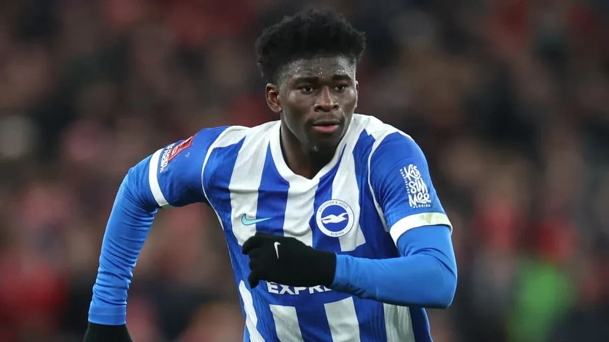 Player running during match in Brighton kit Player running during match in Brighton kit