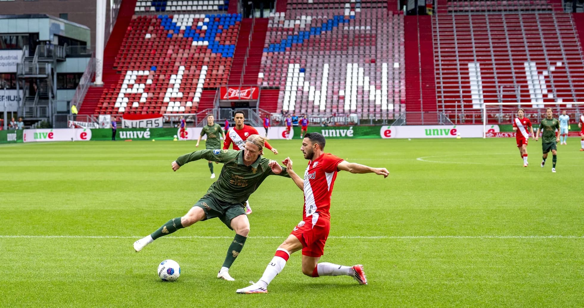 Two players competing for the ball during match Two players competing for the ball during match