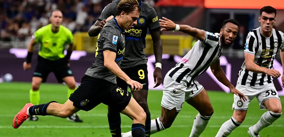 Inter player sprinting past Udinese defenders during match Inter player sprinting past Udinese defenders during match