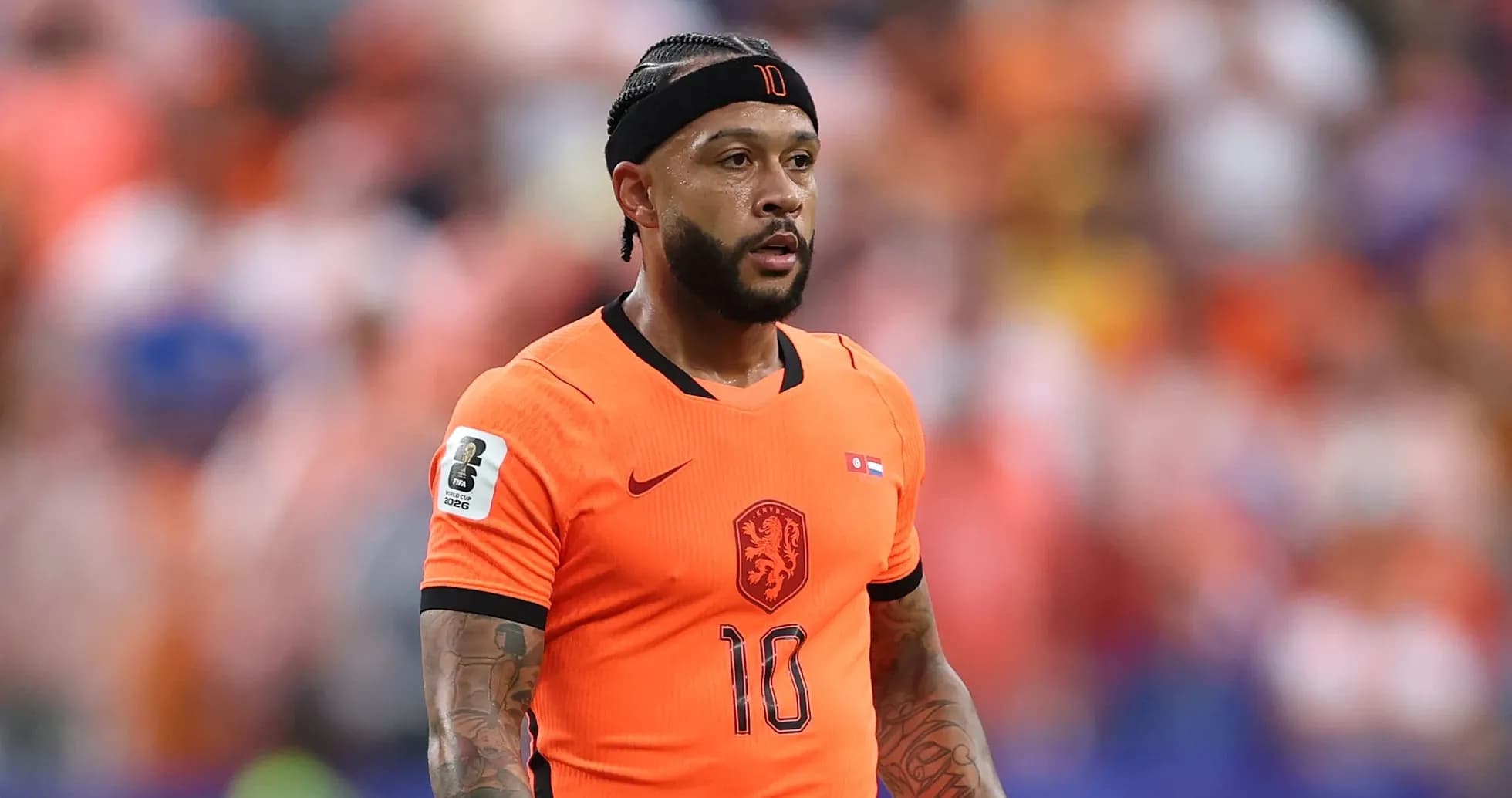 Player in orange jersey during a football match Player in orange jersey during a football match