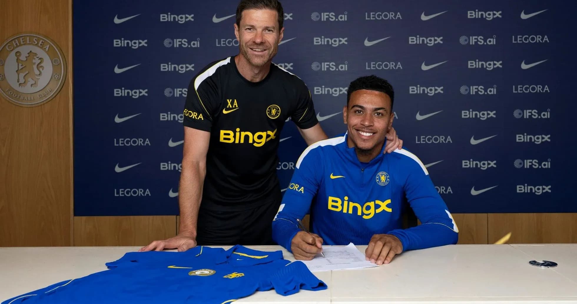 Player signing contract with manager at Chelsea FC Player signing contract with manager at Chelsea FC