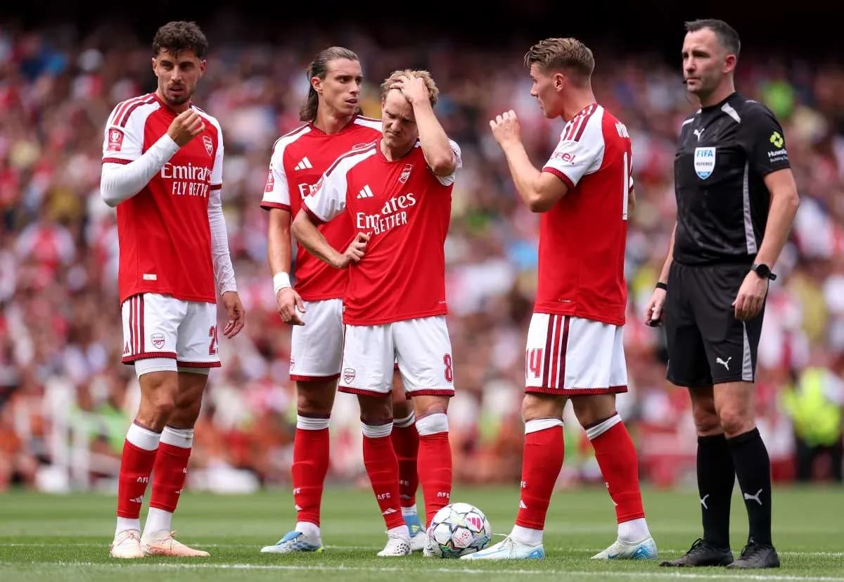 Arsenal players discussing a play with referee Arsenal players discussing a play with referee