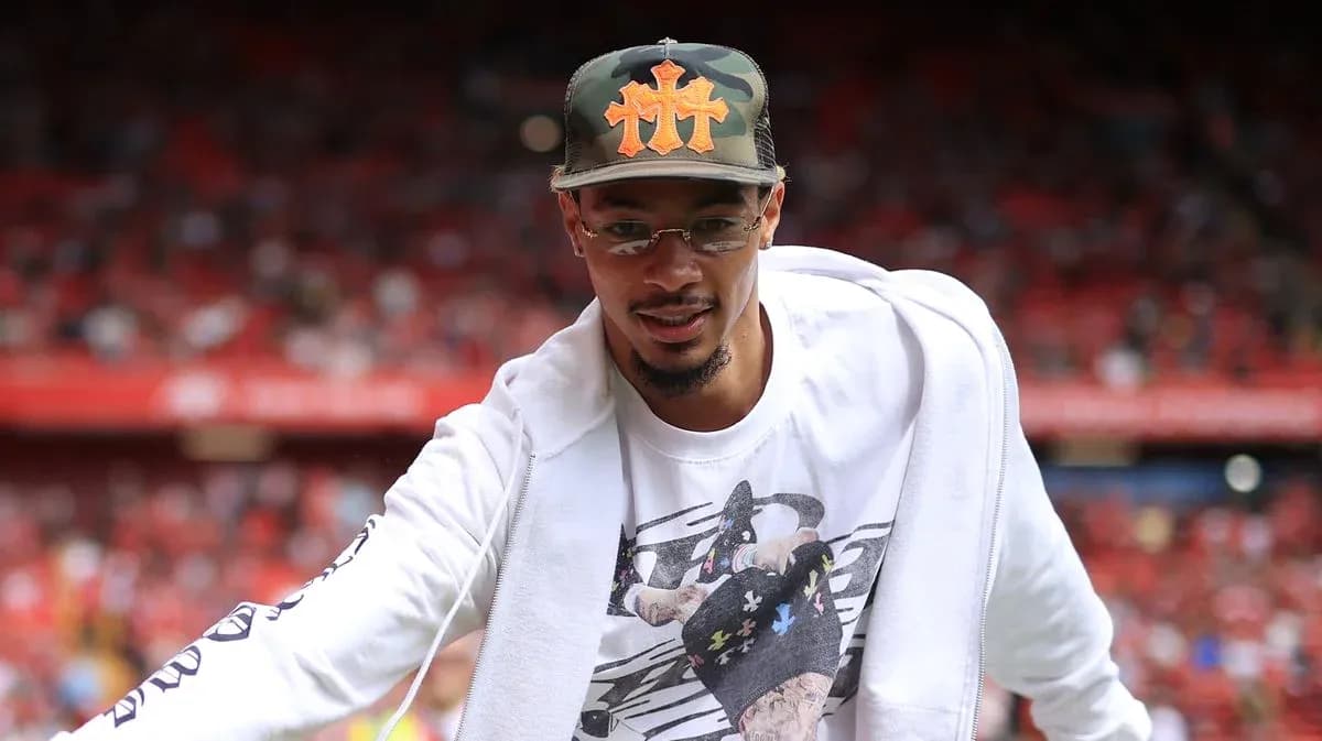 Player greeting fans in stadium before match Player greeting fans in stadium before match
