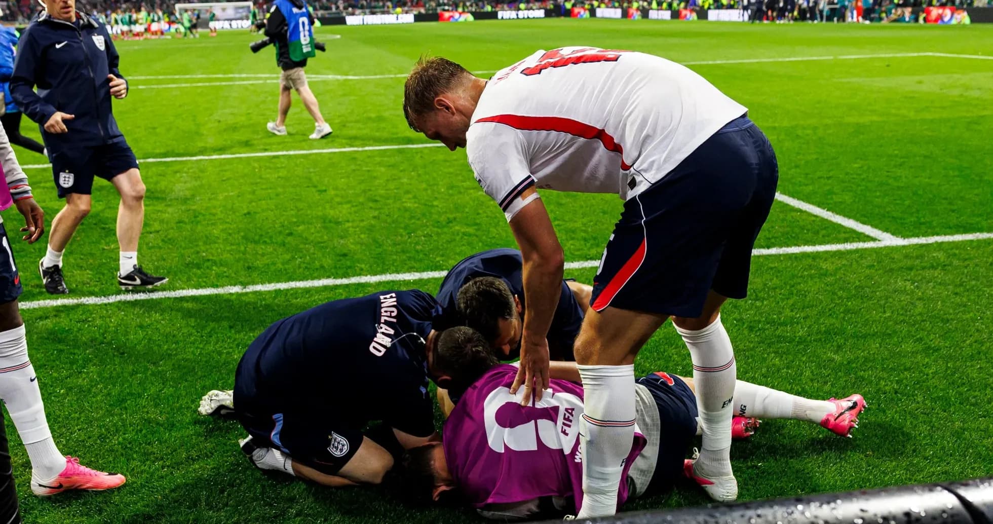 Players and staff attending to injured goalkeeper on field Players and staff attending to injured goalkeeper on field