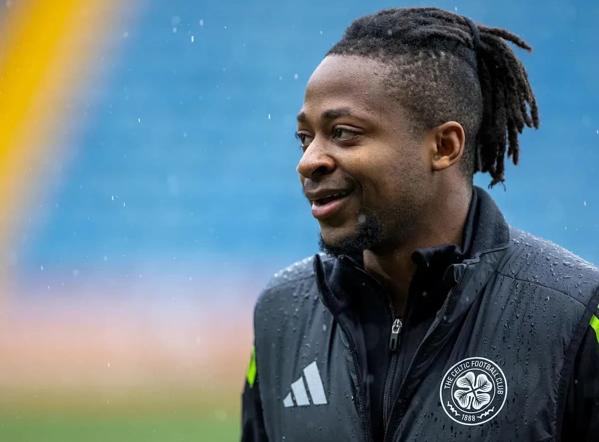 Player in training gear smiling during rain Player in training gear smiling during rain