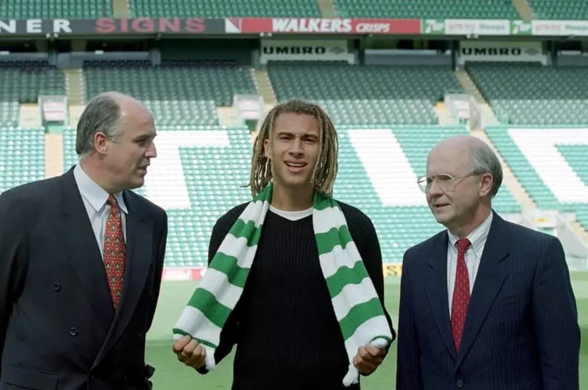 Player holding scarf with two officials at stadium Player holding scarf with two officials at stadium