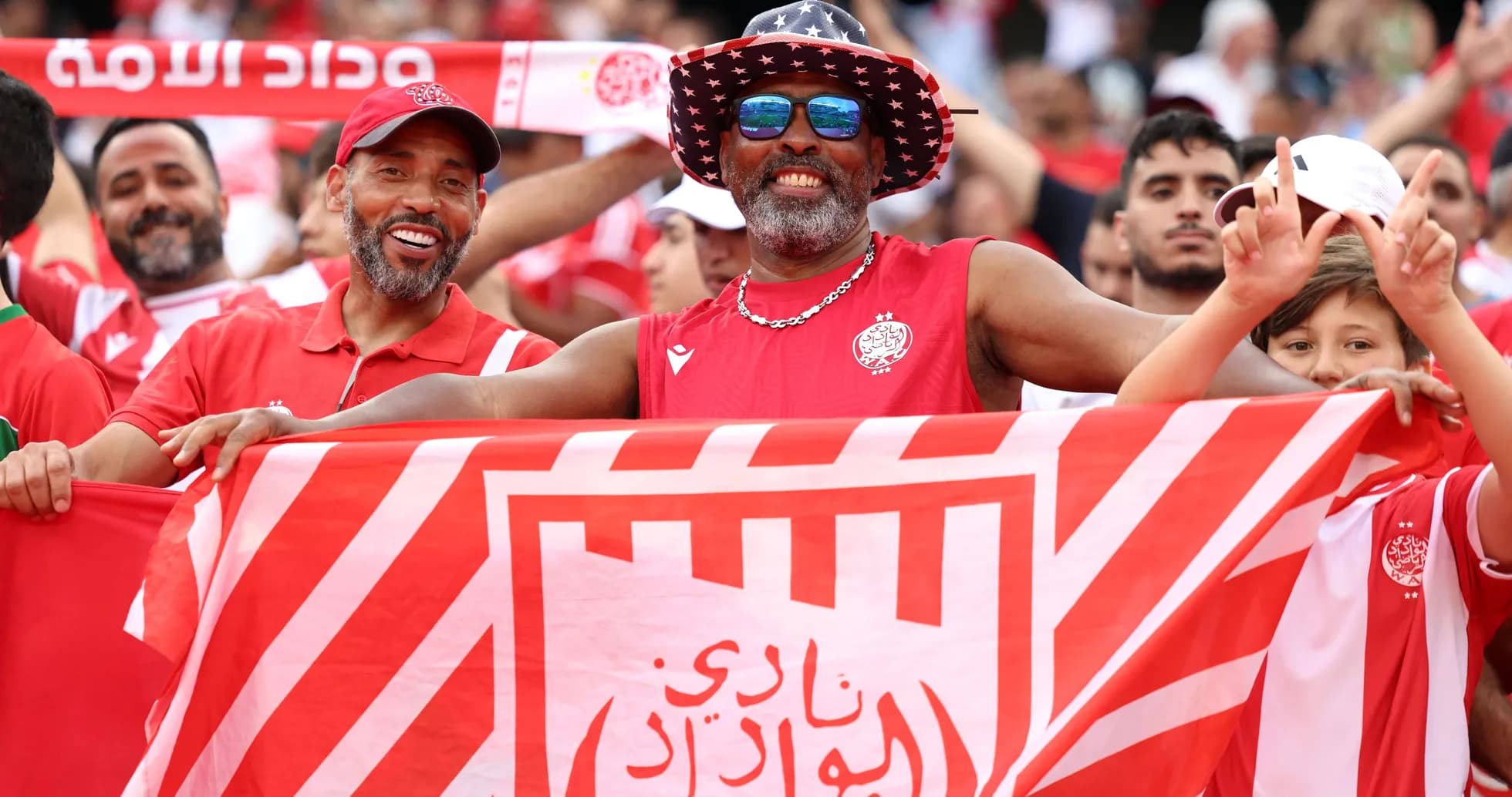 Fans celebrating with a club flag in the stands Fans celebrating with a club flag in the stands