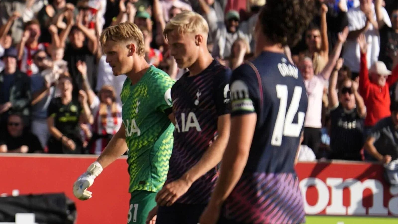 Players walking off the pitch with fans cheering Players walking off the pitch with fans cheering
