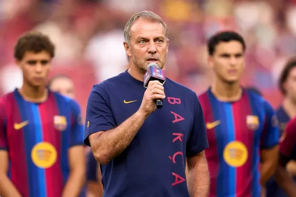 Manager speaking at event with players behind Manager speaking at event with players behind