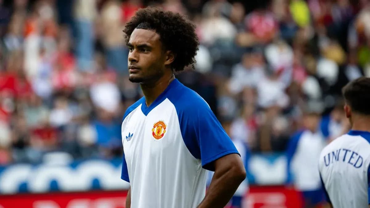 Player in Manchester United training kit on field Player in Manchester United training kit on field