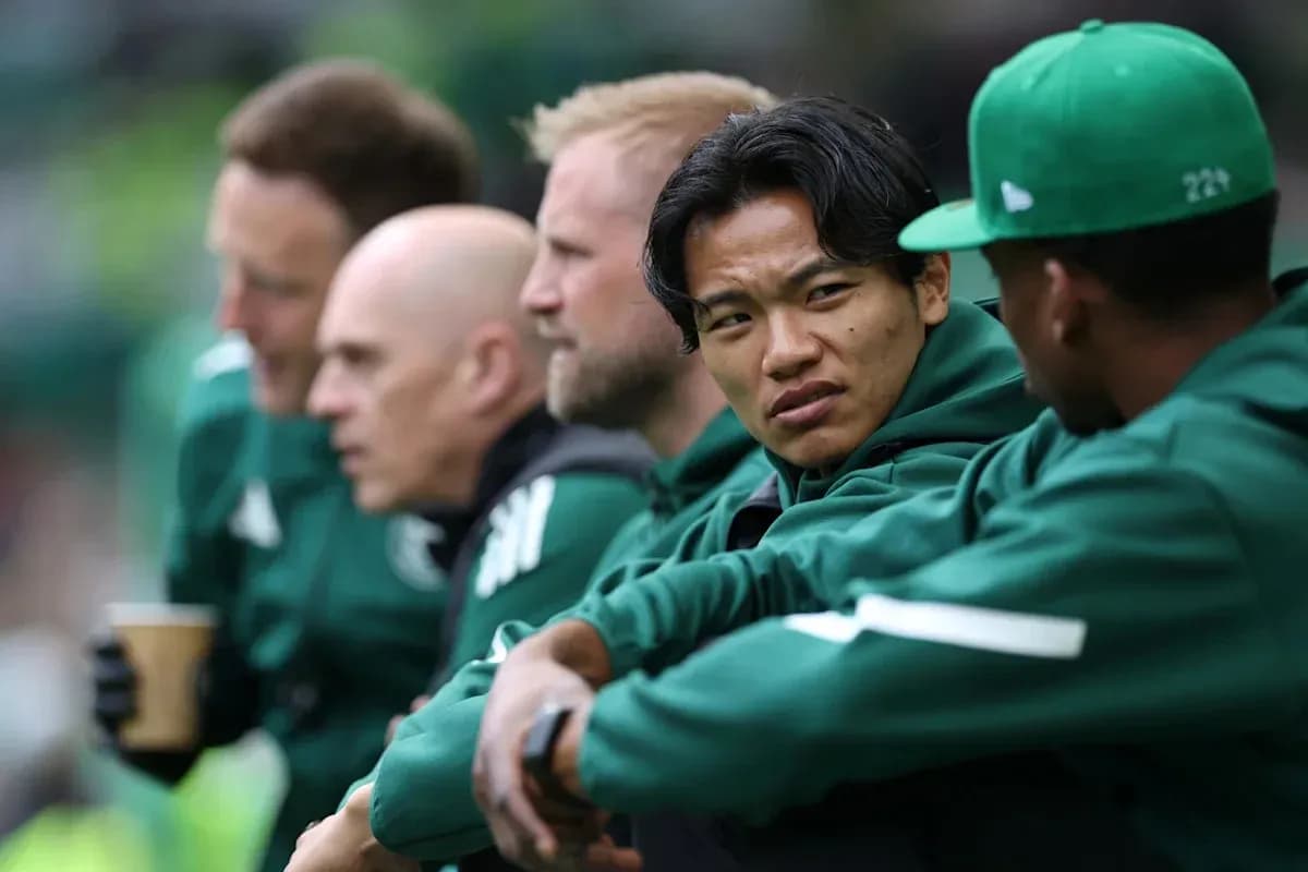 Players sitting on bench during match, wearing team jackets Players sitting on bench during match, wearing team jackets