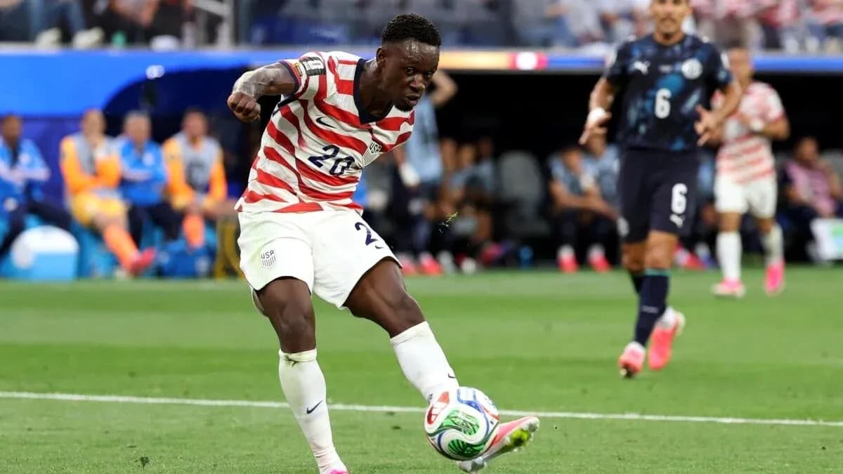 Player in USA kit kicking ball during match Player in USA kit kicking ball during match