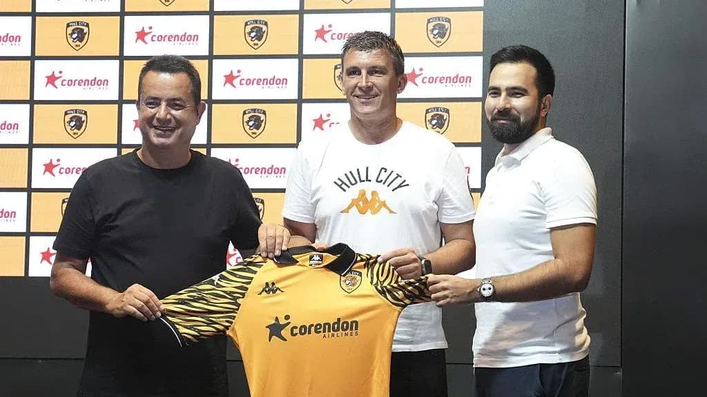 New manager holding Hull City jersey at unveiling New manager holding Hull City jersey at unveiling