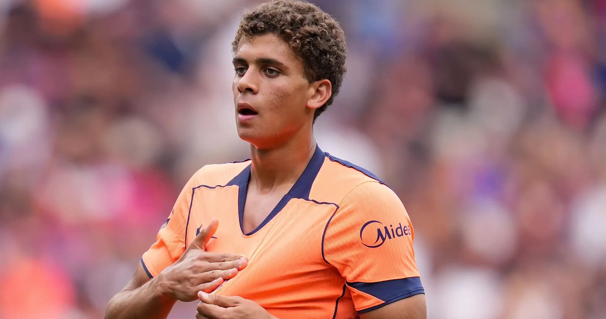 Player adjusting jersey during a match Player adjusting jersey during a match