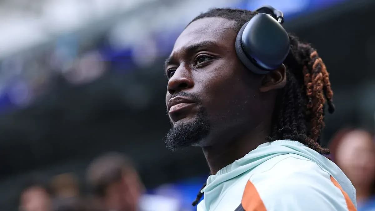 Player wearing headphones on the sidelines Player wearing headphones on the sidelines