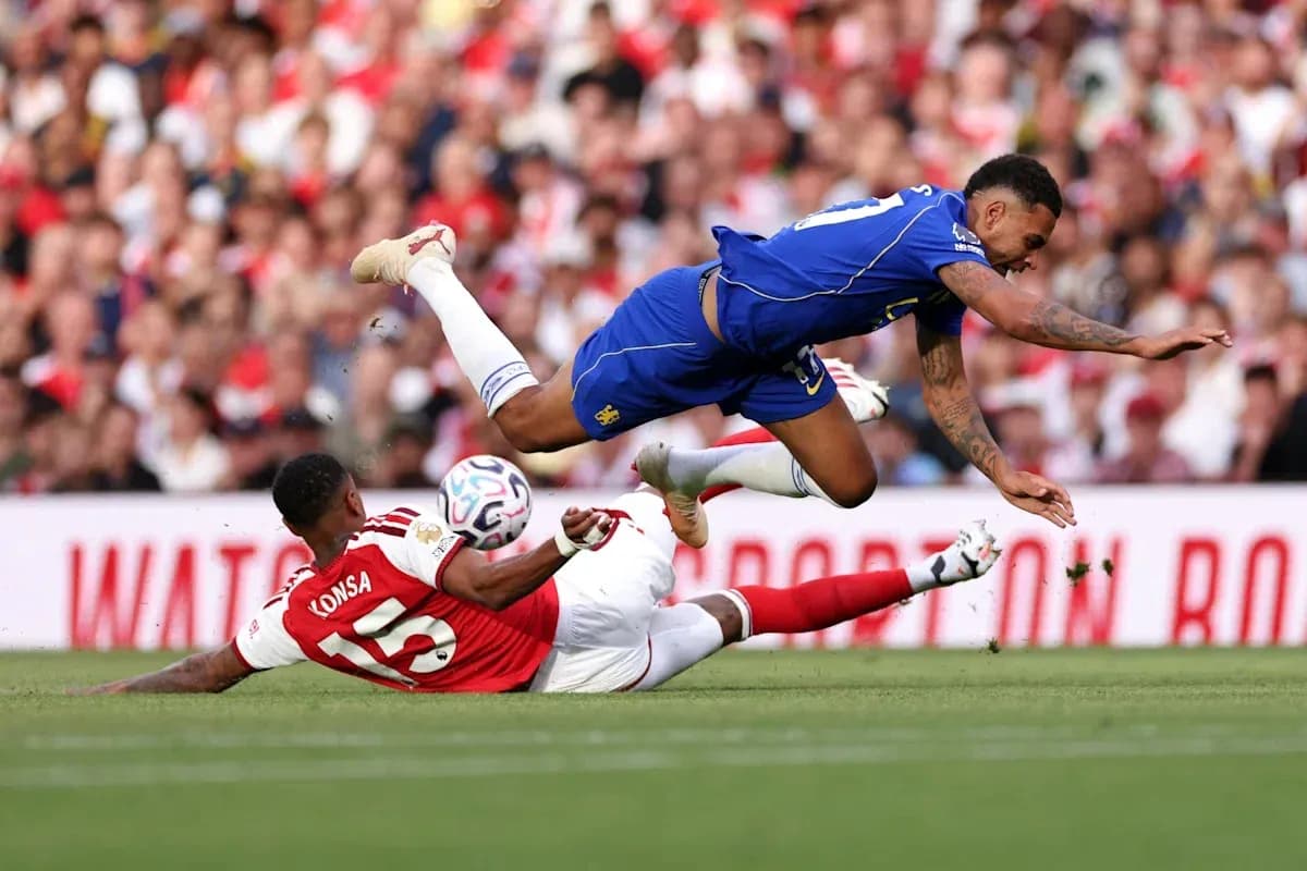 Player tackling another during football match action Player tackling another during football match action