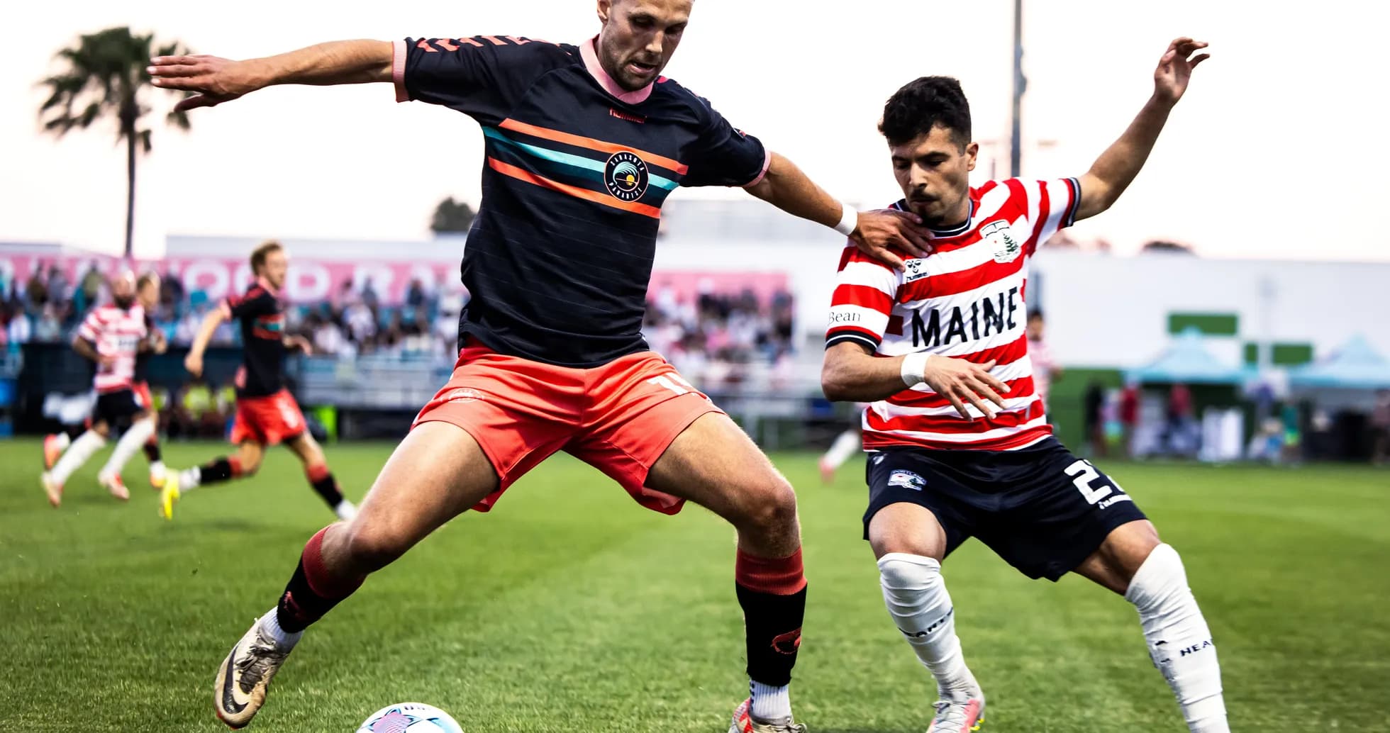 Players competing for the ball in USL match Players competing for the ball in USL match