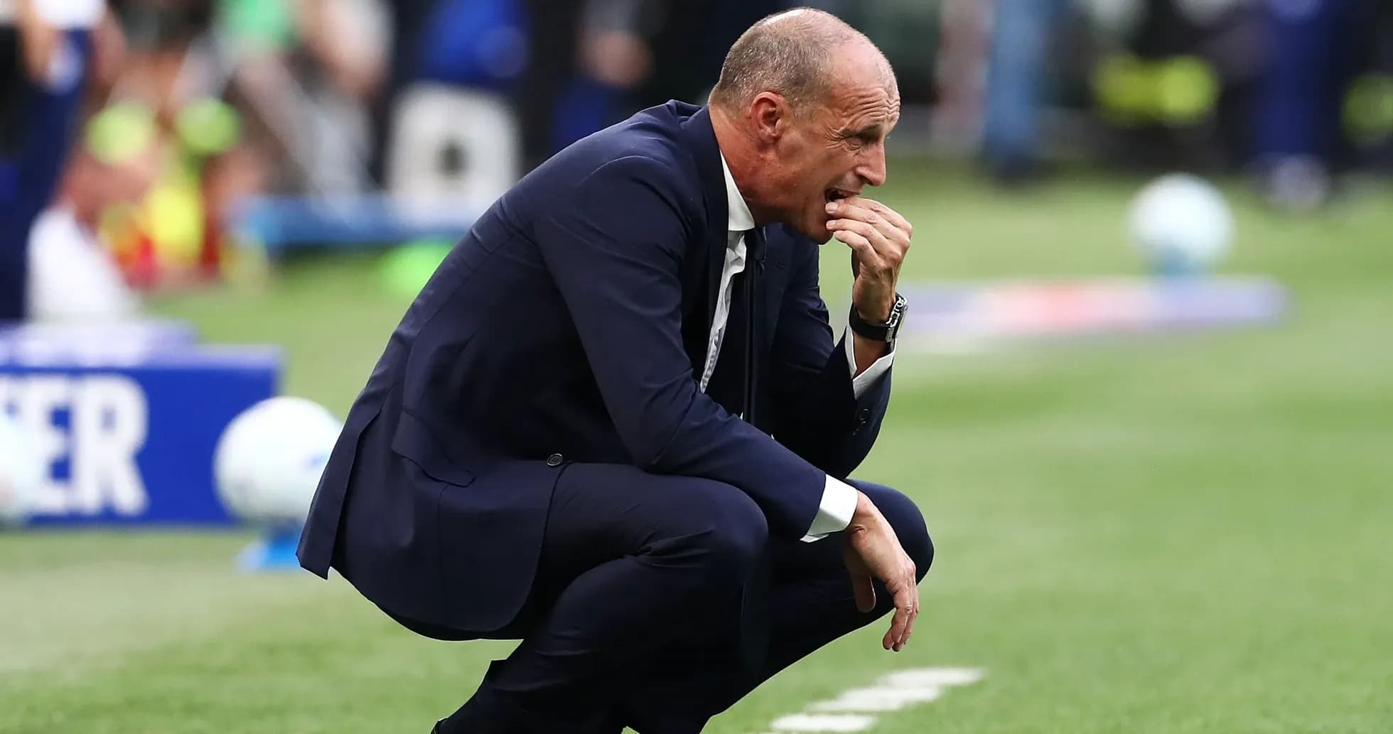 Coach kneeling on sideline during match Coach kneeling on sideline during match