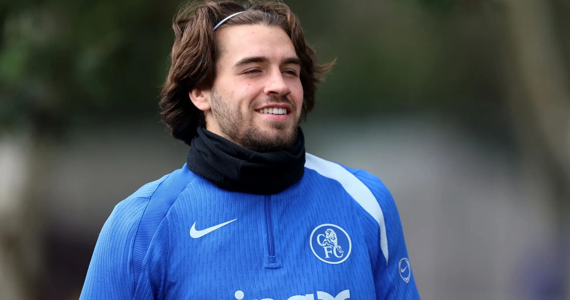 Player in blue training gear smiling outdoors Player in blue training gear smiling outdoors