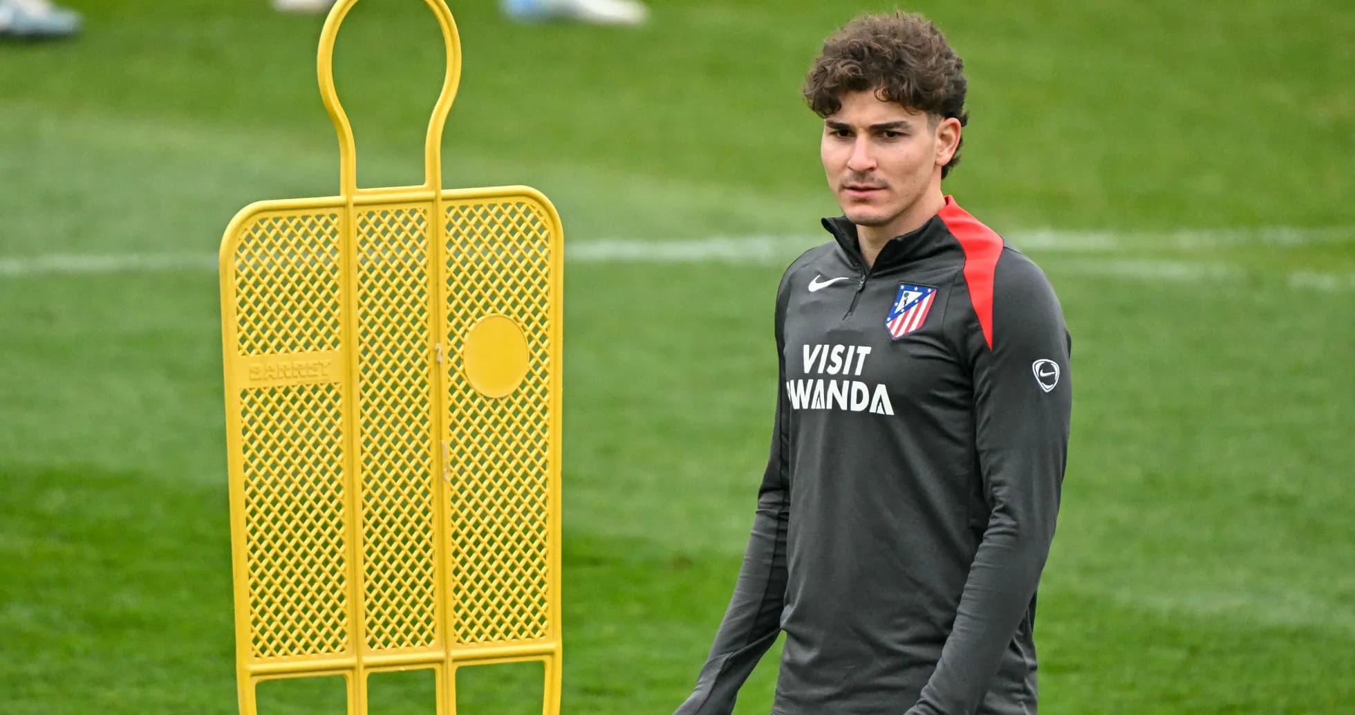 Player standing next to a training dummy on field Player standing next to a training dummy on field