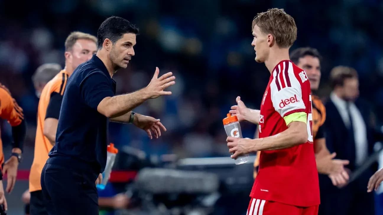 Manager discussing strategy with player on sideline Manager discussing strategy with player on sideline