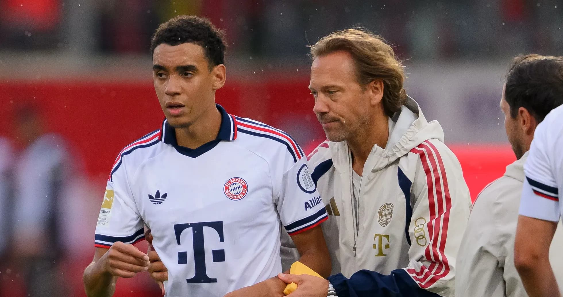 Bayern Munich player receiving instructions from coach Bayern Munich player receiving instructions from coach