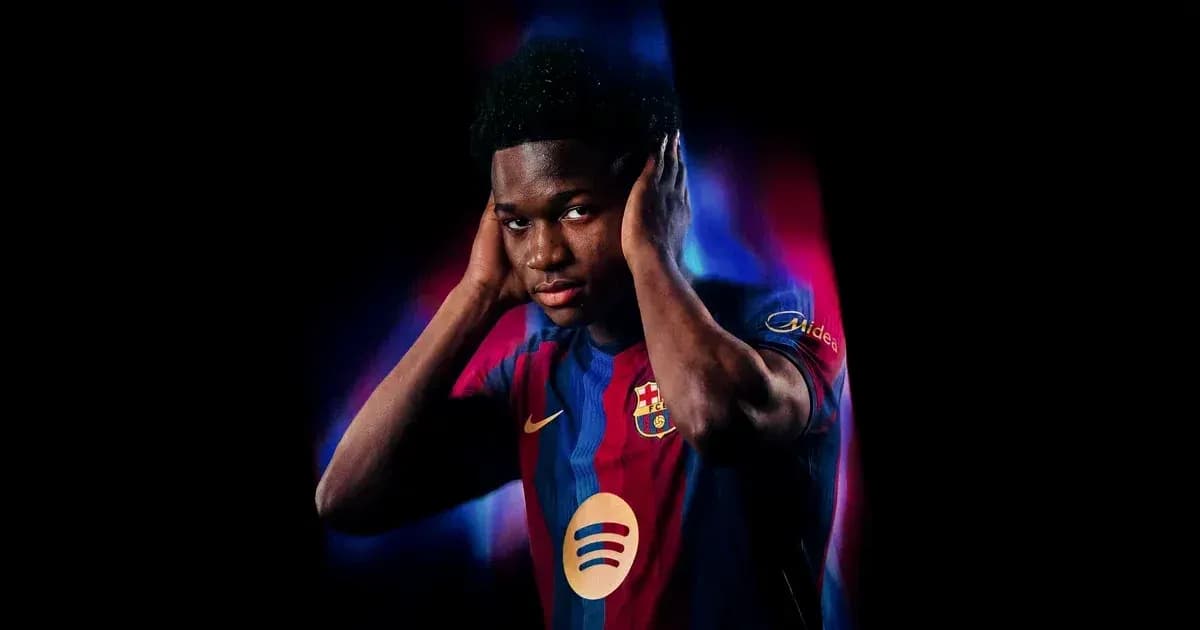 Player wearing FC Barcelona jersey posing with hands on ears Player wearing FC Barcelona jersey posing with hands on ears