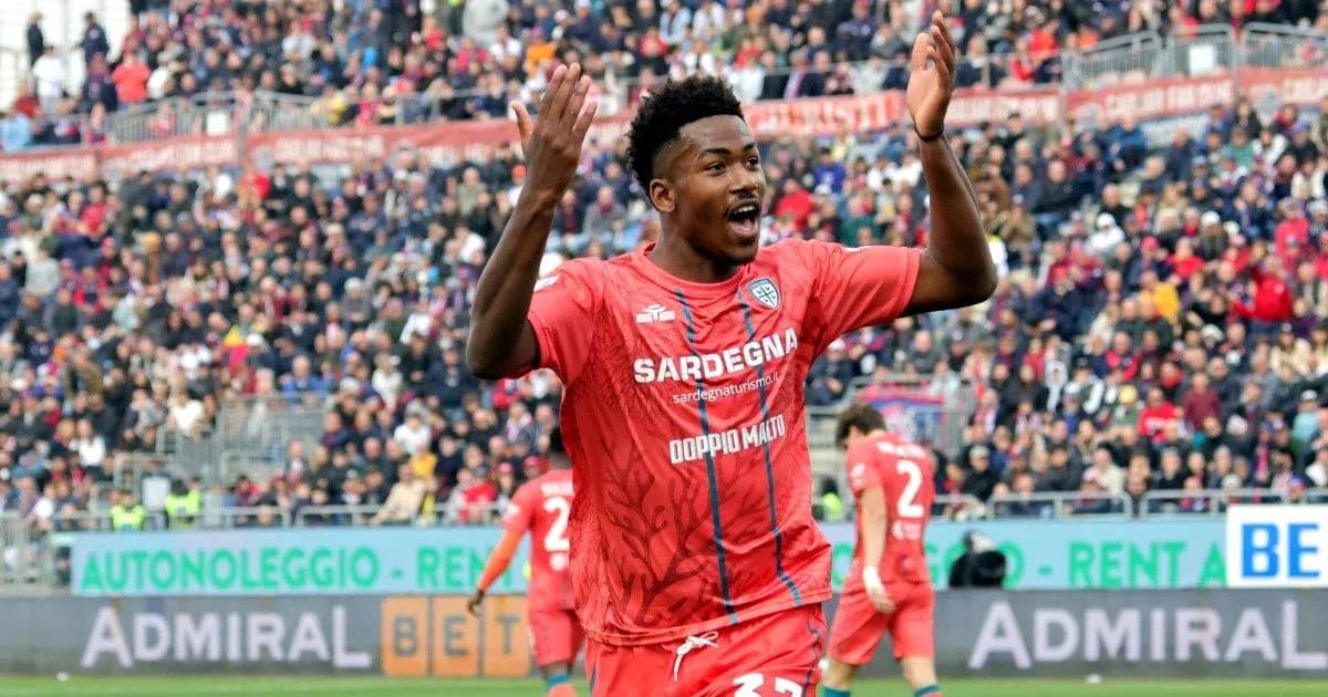 Player celebrating during match with crowd in background Player celebrating during match with crowd in background