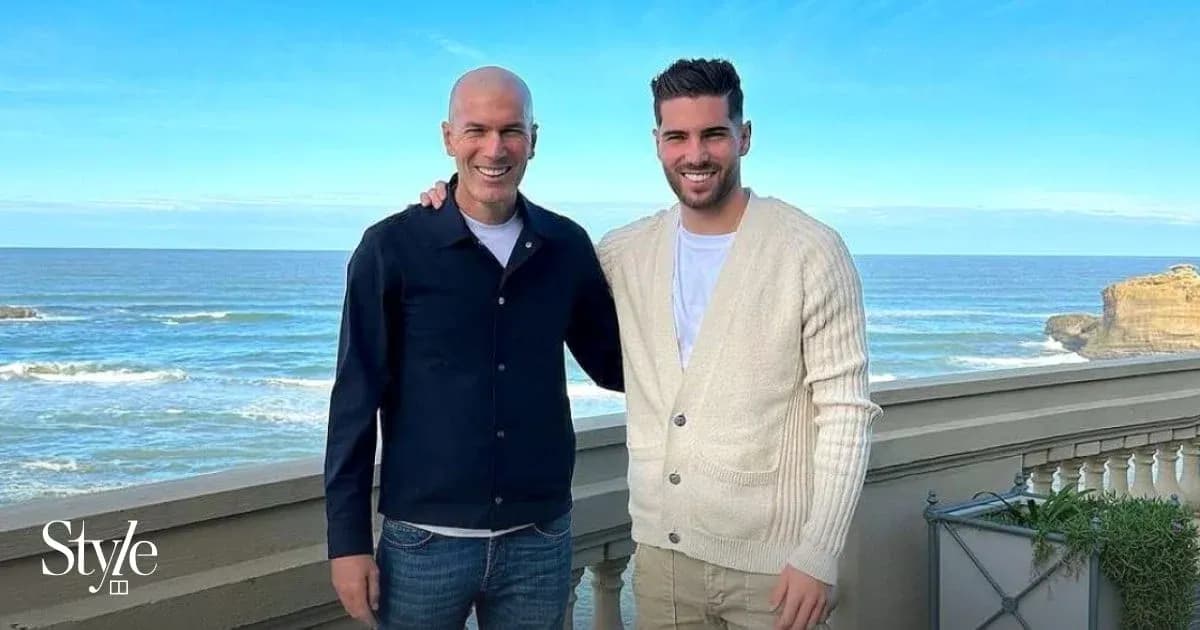 Two men posing together with ocean backdrop Two men posing together with ocean backdrop