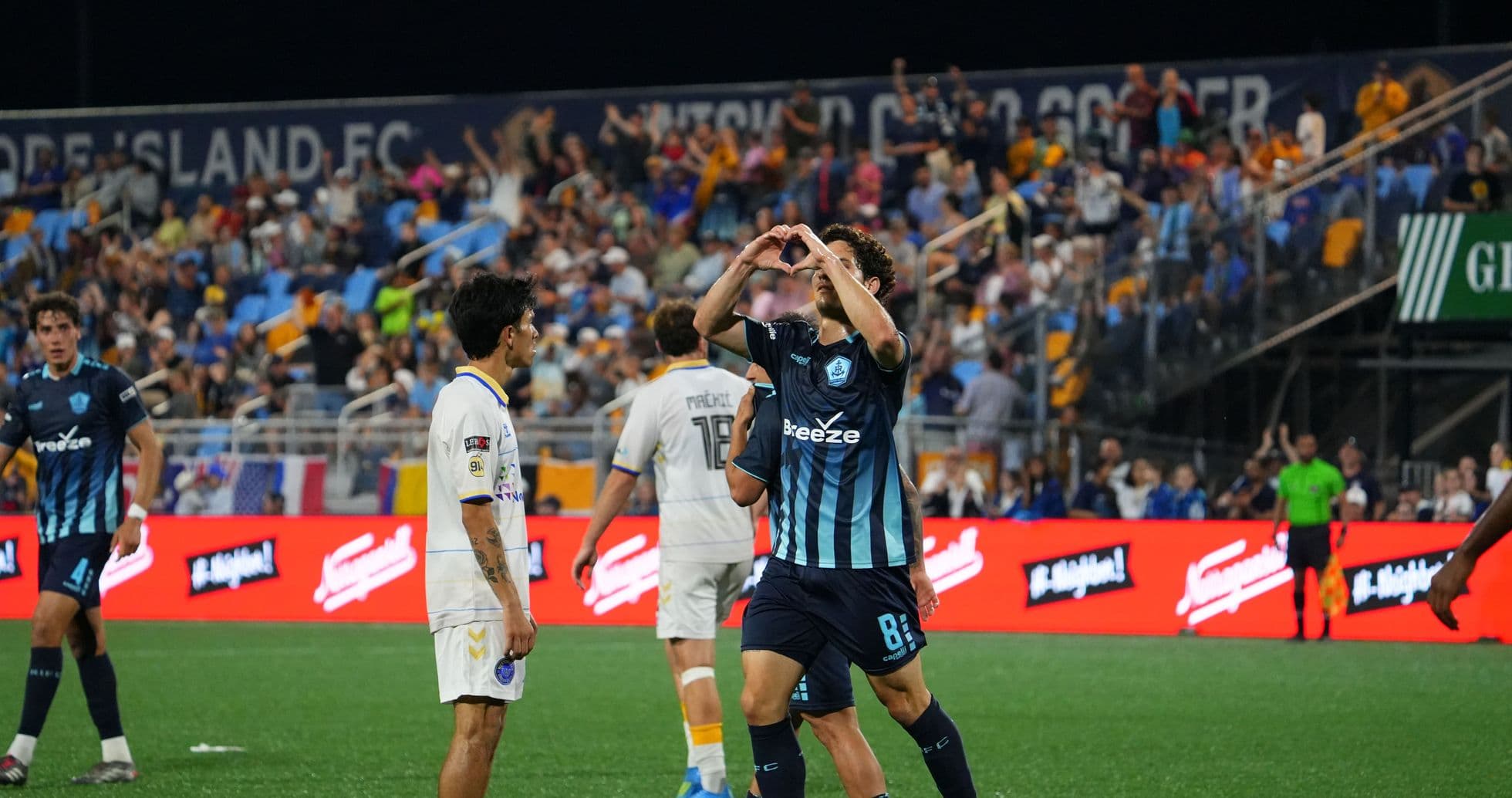Player celebrating goal during Rhode Island match Player celebrating goal during Rhode Island match