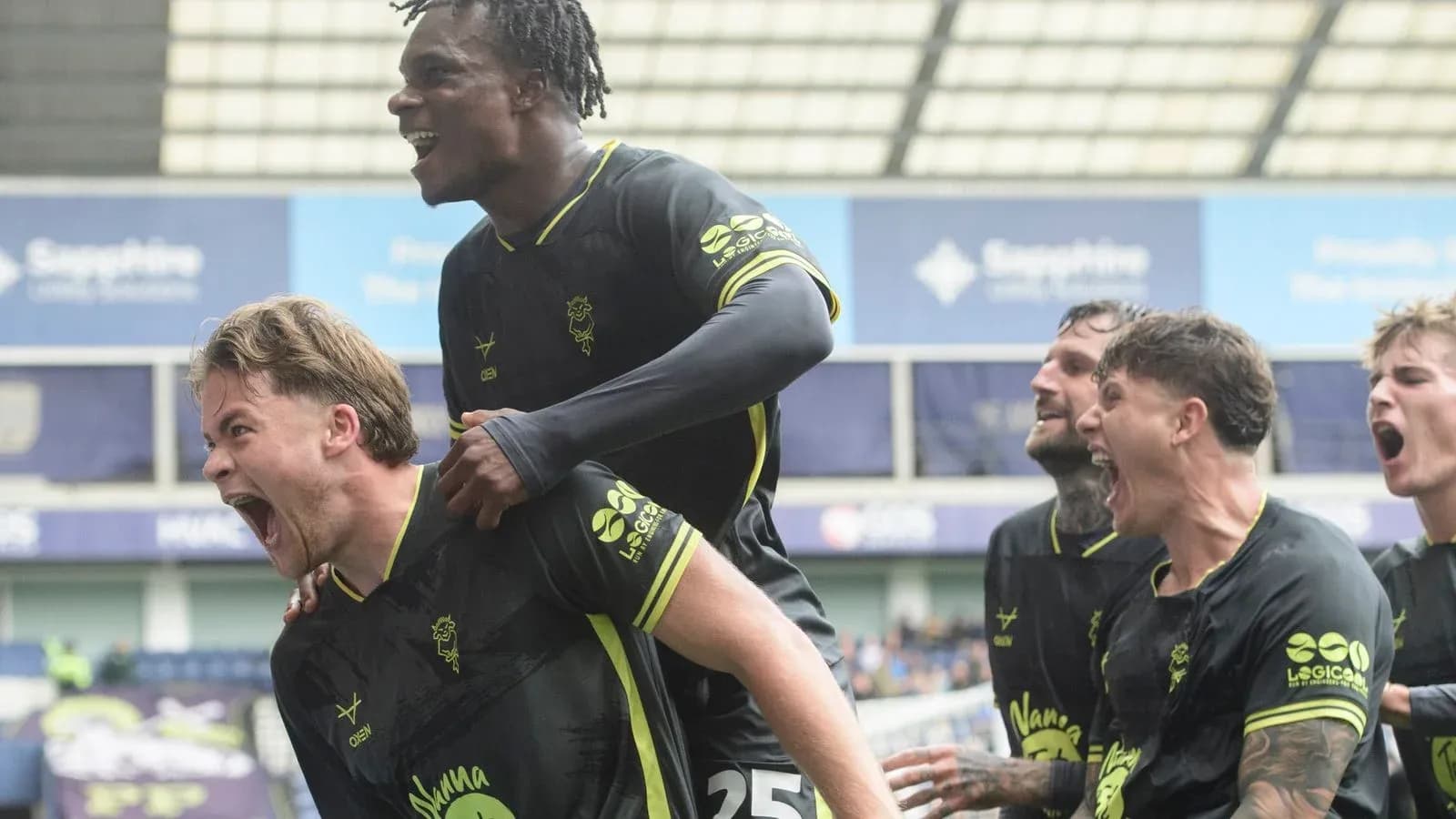 Players celebrating a goal during a match Players celebrating a goal during a match