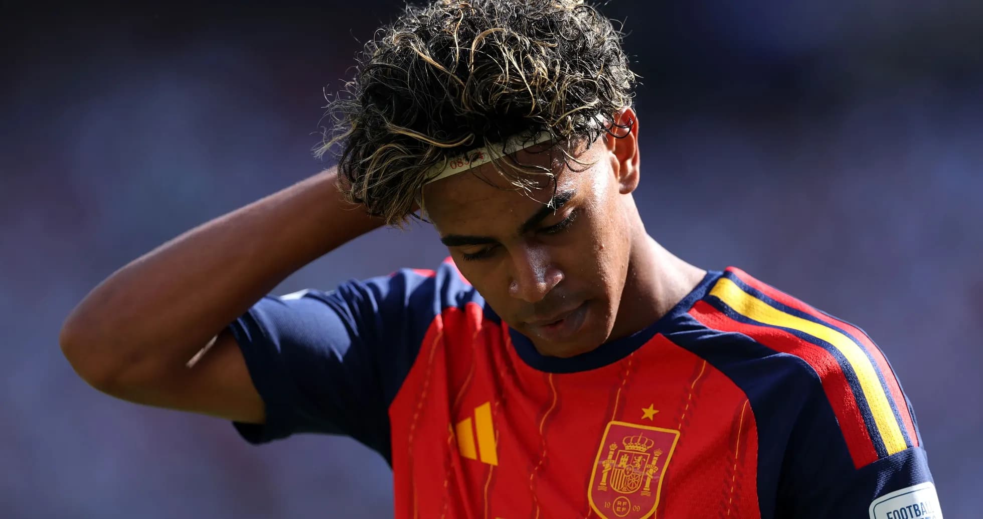 Player in Spain jersey looking down on field Player in Spain jersey looking down on field