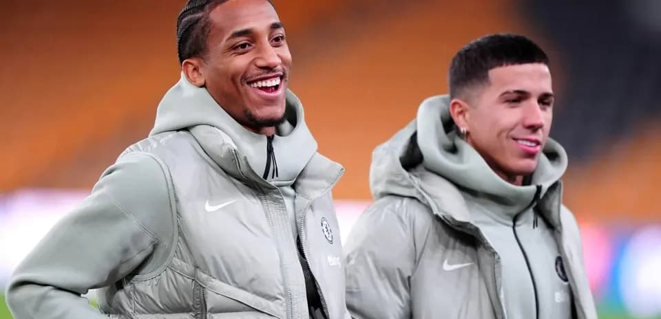 Two players smiling during warm-up in training jackets Two players smiling during warm-up in training jackets
