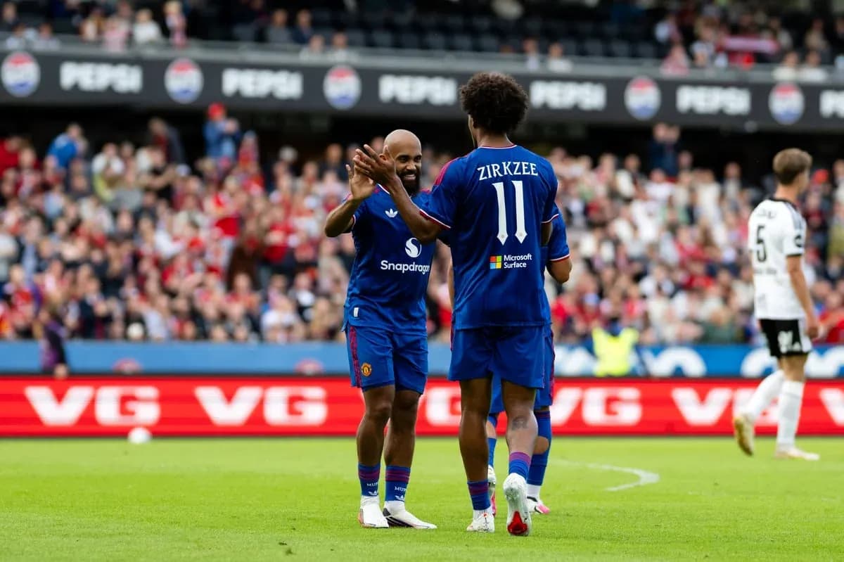 Two players celebrating on the pitch during match Two players celebrating on the pitch during match
