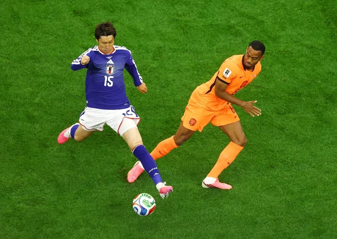 Player from Japan and Netherlands competing for ball Player from Japan and Netherlands competing for ball