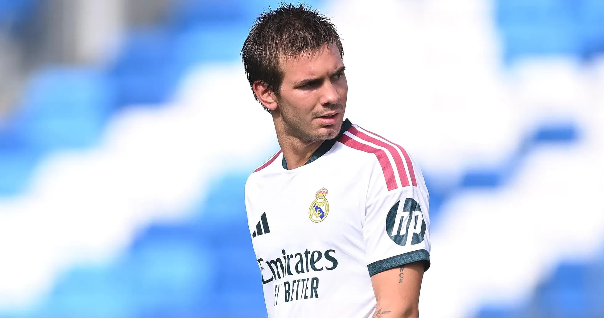 Football player in Real Madrid jersey on field Football player in Real Madrid jersey on field