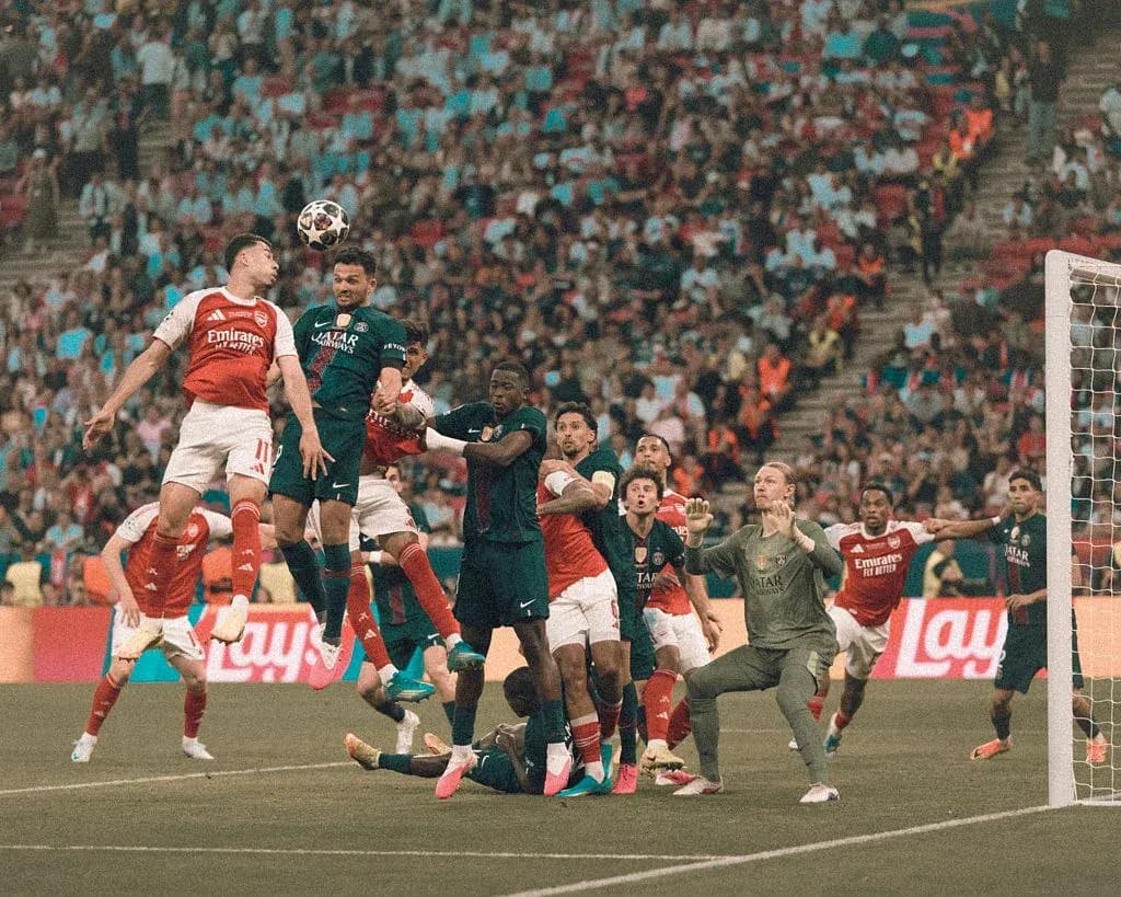 Players contesting a high ball during match action Players contesting a high ball during match action