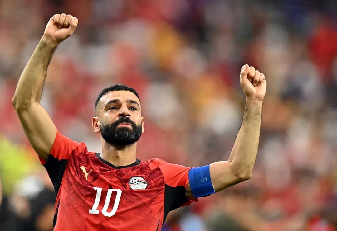 Player celebrating with raised fists on the field Player celebrating with raised fists on the field