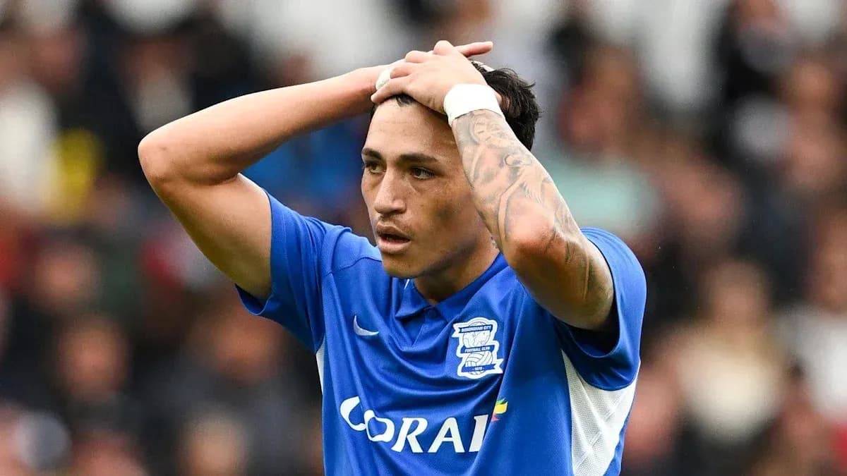 Player in blue jersey holding head in frustration Player in blue jersey holding head in frustration