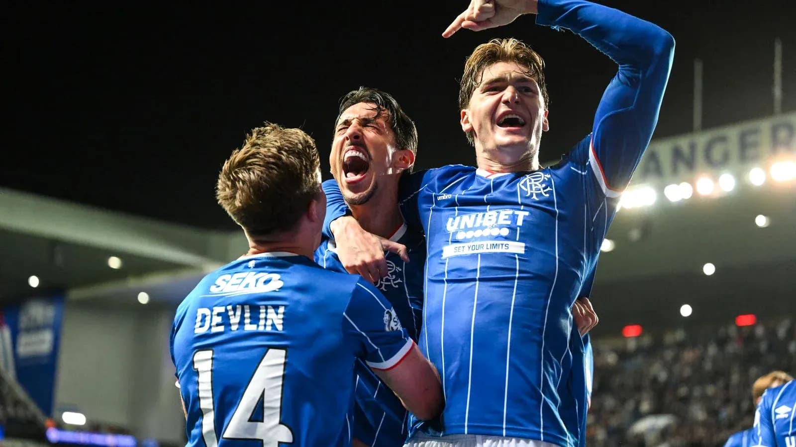 Rangers players celebrating a goal in the stadium Rangers players celebrating a goal in the stadium