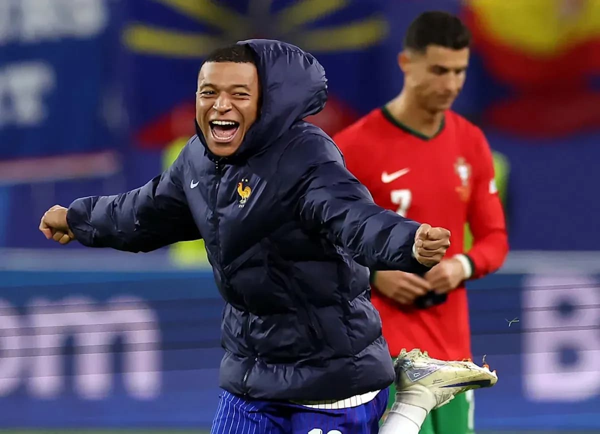 Kylian Mbappé celebrating in warm-up jacket during match Kylian Mbappé celebrating in warm-up jacket during match