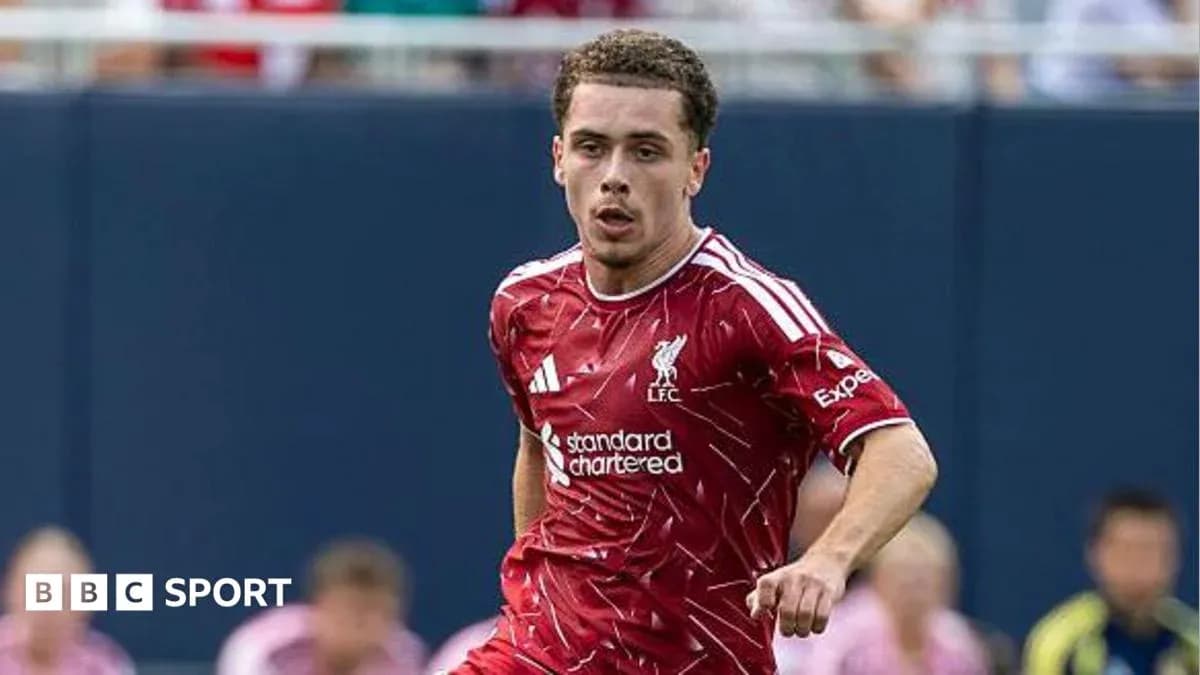 Player running on field wearing Liverpool jersey Player running on field wearing Liverpool jersey