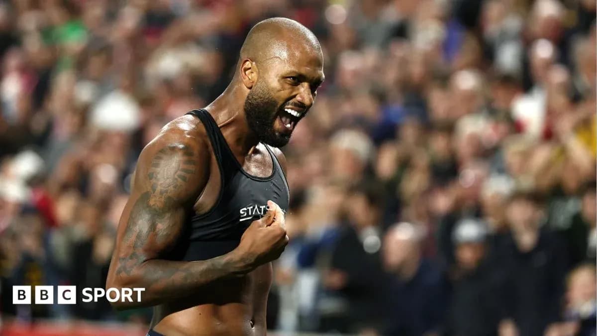 Athlete celebrating with crowd in background Athlete celebrating with crowd in background