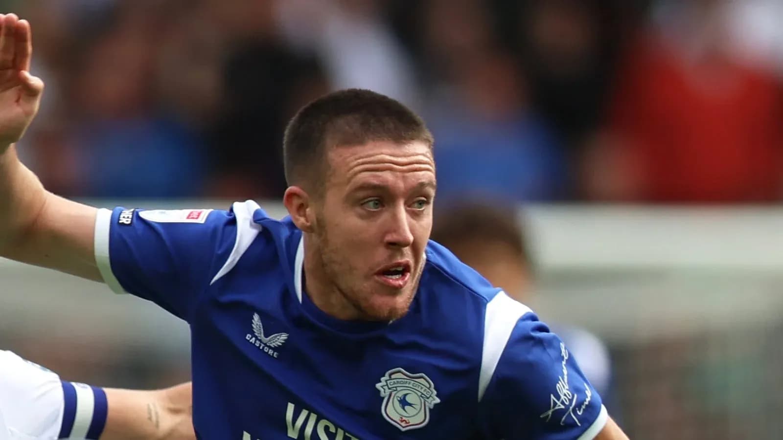 Player in blue jersey running during match action Player in blue jersey running during match action